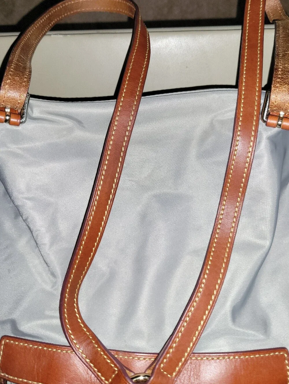 Dooney & Bourke Light Gray Nylon Backpack with Brown Leather Trim.